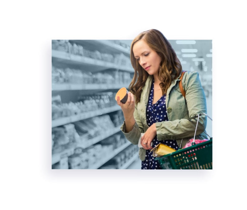 person reading label at grocery store