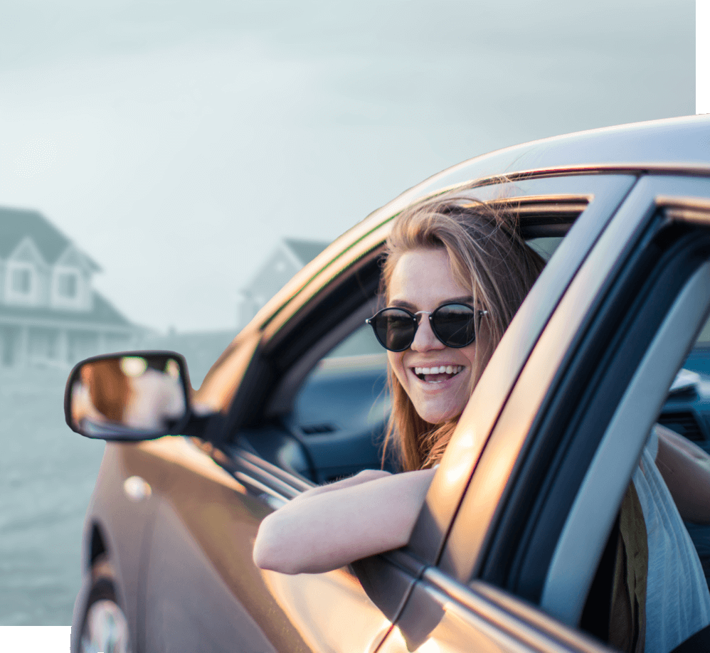 person looking out driver window at camera