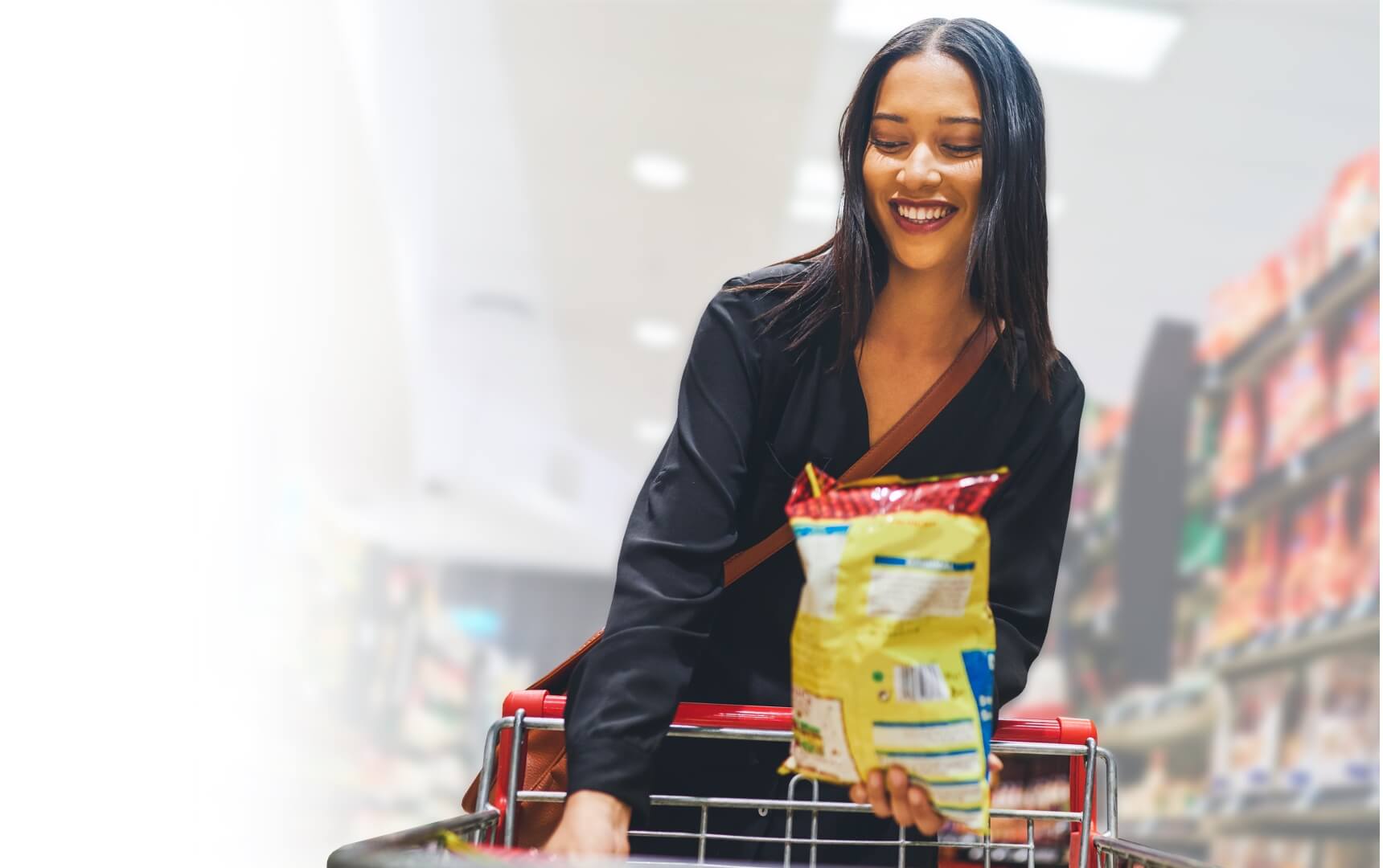 shopper putting bag of chips in cart