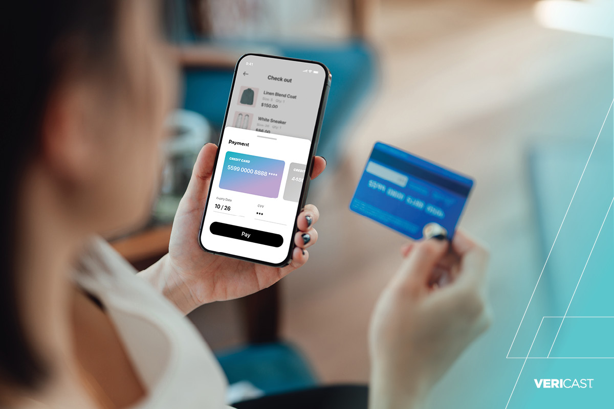 Woman loading her debit card onto her phone.